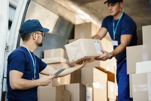 Delivery Men unloading cardboard boxes