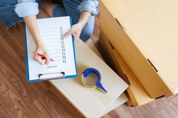 Woman checking package before relocating and moving to new house